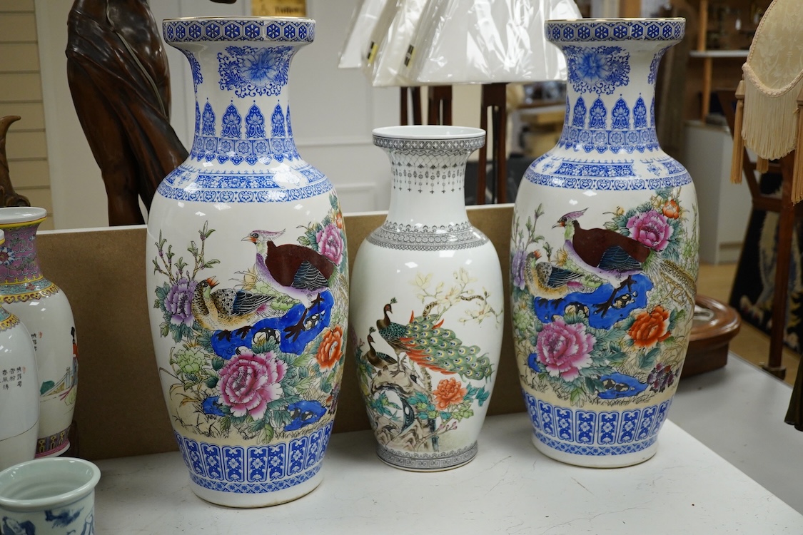 A large pair of Chinese polychrome vases, 60cm high, a pair of famille rose vases, a blue and white brushpot and two other vases (7).